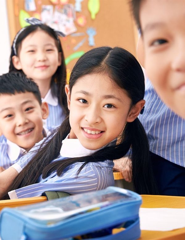 Children smiling in a Brightpath classroom