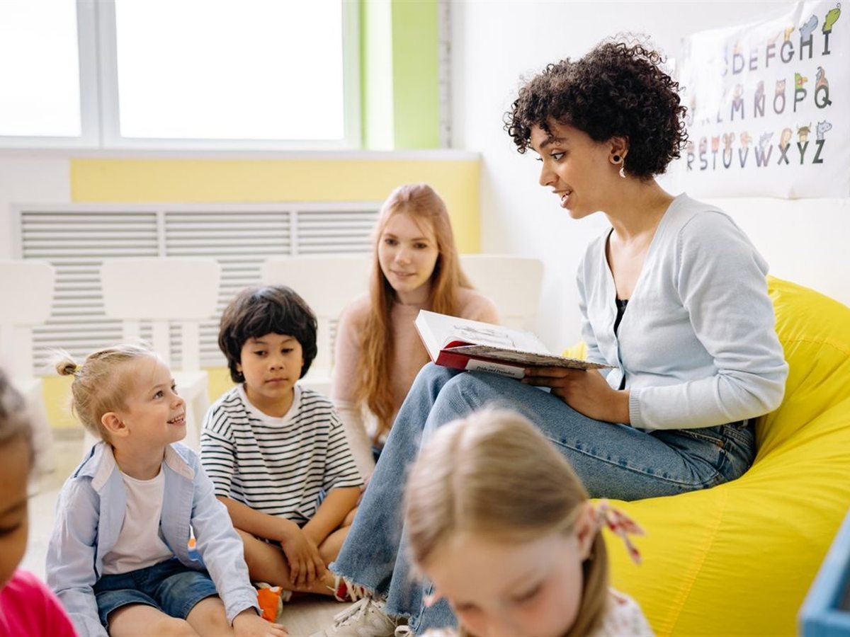 An educator reading with a group of children